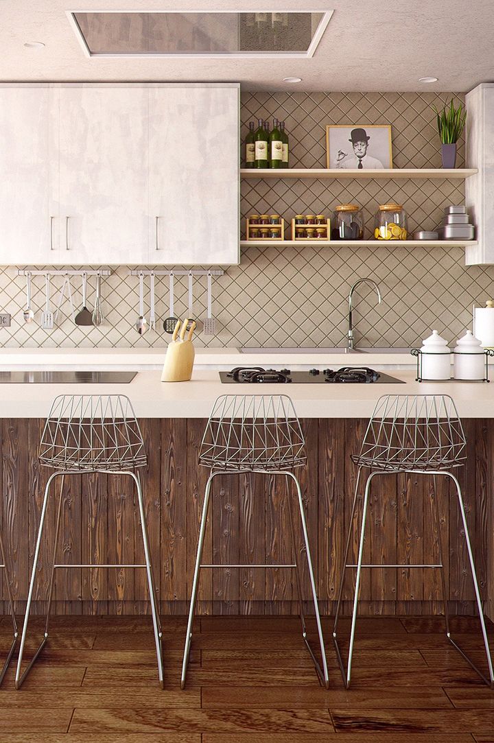 Imagen donde se ve parte de una cocina con tres taburetes.